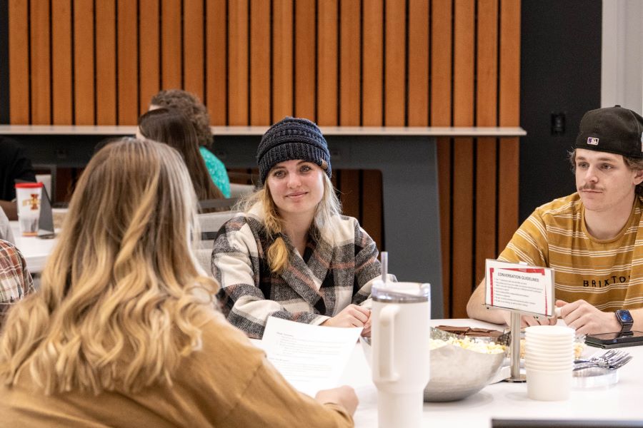 Students listen to a facilitator introduce conversation questions at the 2024 Building Our Community event.