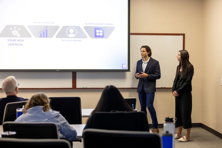 Students present their case recommendations to company judges.