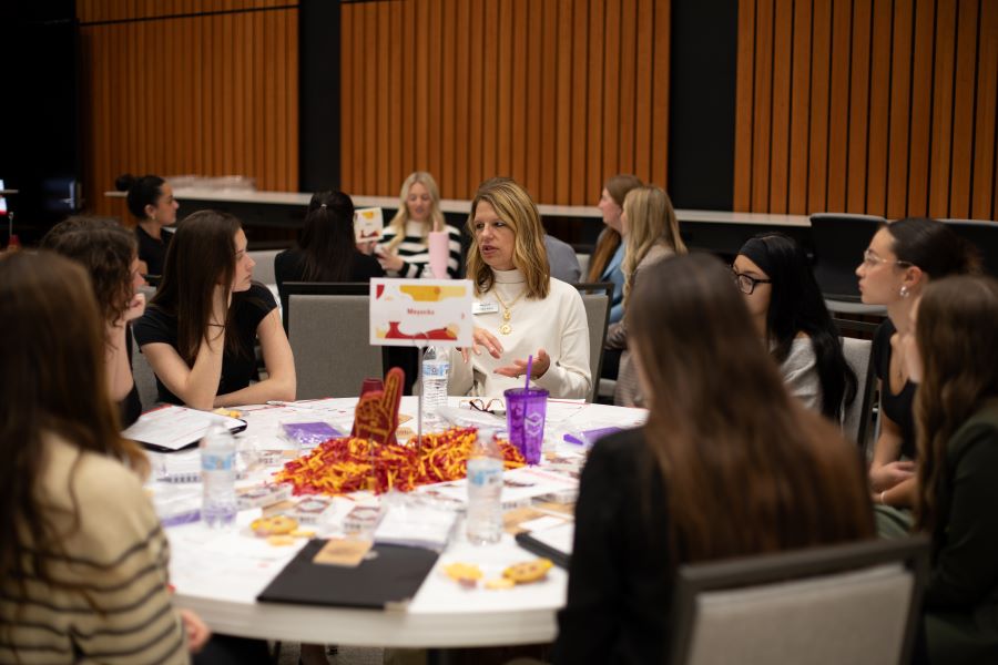 Students listen to employer representatives at an Ivy career event.